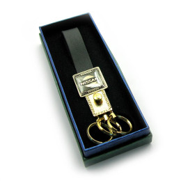 Keychain car with a leather strap "Nissan" gold (19332K)